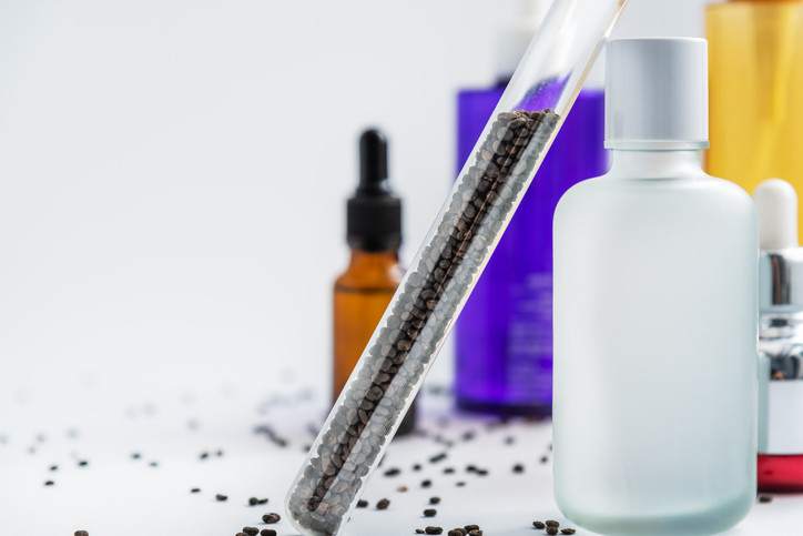 Bakuchiol seeds in glass tube and cosmetics bottles
